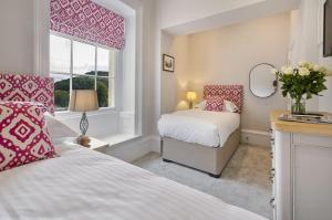 a bedroom with two beds and a window at Waterfoot Park in Pooley Bridge
