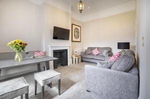 a living room with a couch and a table at Waterfoot Park in Pooley Bridge