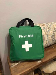 a green first aid bag sitting on a bench at House Fynbos, 4 Bedroom house in Bloemfontein