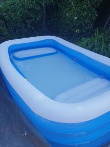 a blue and white bath tub in a backyard at Harry Potter theme Double room in shared house in Garston