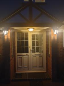 une porte d'entrée d'une maison éclairée dans l'établissement Harry Potter theme Double room in shared house, à Garston