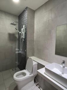 a bathroom with a toilet and a sink and a shower at Kota Kinabalu City Centre @ The Shore by Casa Yolo in Kota Kinabalu