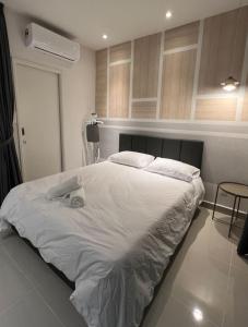 a bedroom with a large white bed in a room at Kota Kinabalu City Centre @ The Shore by Casa Yolo in Kota Kinabalu