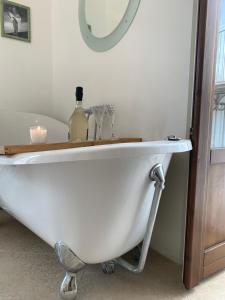 a white bath tub in a bathroom with a mirror at Casa di Carolina Italian Holiday Home in Pacentro