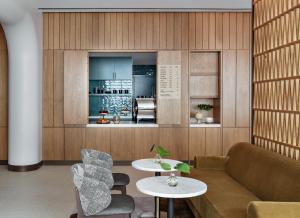 a living room with a couch and a table at Kimpton Hotel Theta, an IHG Hotel in New York