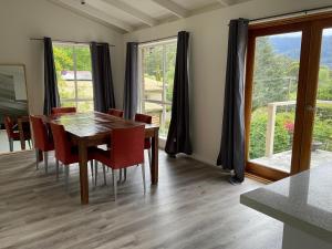 a dining room with a wooden table and chairs at Warburton Waterfalls in Warburton