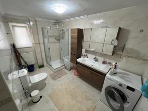 a bathroom with a toilet sink and a washing machine at Urban Comfort in Nisantasi - Central & Spacious in Istanbul