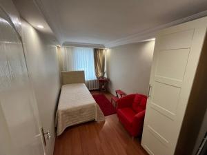 a small room with a red couch and a red chair at Urban Comfort in Nisantasi - Central & Spacious in Istanbul