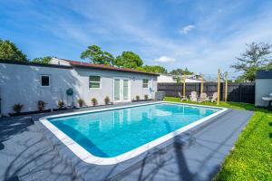 a swimming pool in the yard of a house at Trendy Family Home -Heated Pool in Hollywood