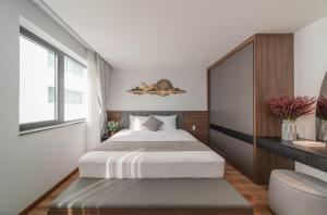 a bedroom with a large bed and a window at Khang's House in Nha Trang +15 photos