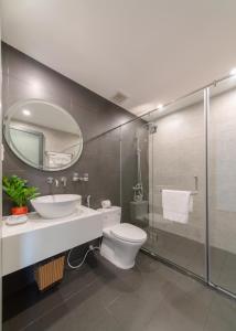a bathroom with a toilet and a sink and a mirror at Khang's House in Nha Trang +17 photos