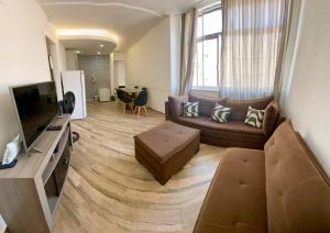a living room with a couch and a television at Apartamento Xavier 15 in Rio de Janeiro