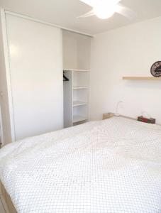 ein Schlafzimmer mit einem weißen Bett in einem Zimmer in der Unterkunft Comfortable accommodation for 4 people in Toulon
