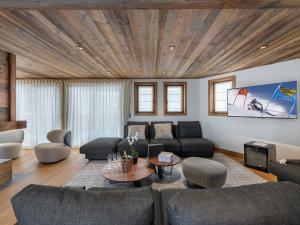a living room with a couch and a table at Chalet neuf avec piscine, sauna et proche des pistes à Courchevel Village - FR-1-562-49 in Courchevel