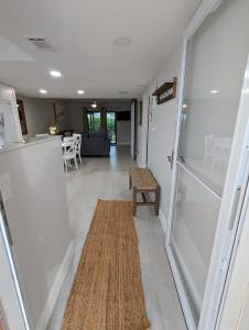 a hallway with a refrigerator and a rug on the floor at NEW condo! Just 15 min to Ft Myers and Sanibel beach! Great Location!! in Fort Myers