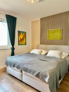 a bedroom with a large bed and a window at Ferienhaus Oldenburg in Oldenburg +45 photos