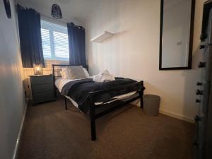 ein kleines Schlafzimmer mit einem Bett und einem Fenster in der Unterkunft CONTRACTORS OR FAMILY HOUSE M1 Nottingham - IKEA RETAIL PARK - SWINDON CLOSE - 2 Bed Home with Driveway, private garden, sleeps 4 - TV'S in all rooms in Giltbrook + 3 Fotos