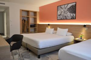 Postel nebo postele na pokoji v ubytování Hotel des Congrès
