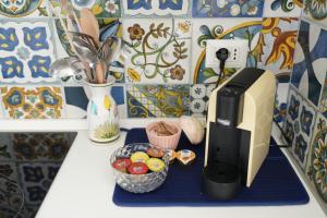 a computer monitor sitting on a counter in a kitchen at Palazzo Manzoni Apartments in Bari