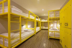 a bunk room with yellow bunk beds in it at Chang Chang Hostel in Chiang Mai