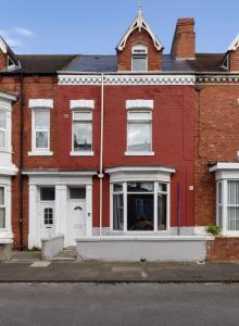 a red brick building with white doors and windows at No 1 Thornhill House in Hartlepool