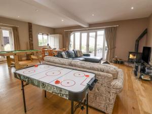 a living room with a ping pong table in it at Hillside House in Kelsall
