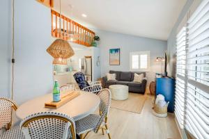 a living room with a table and chairs and a couch at Tropical Cottage Less Than 2 Mi to Hobe Sound Beach! in Hobe Sound