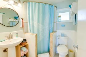 a bathroom with a shower curtain and a sink at Tropical Cottage Less Than 2 Mi to Hobe Sound Beach! in Hobe Sound +20 photos