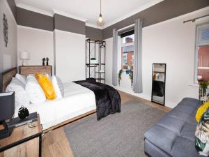 a living room with a bed and a couch at Pass the Keys Beautifully refurbished home close to City in Manchester