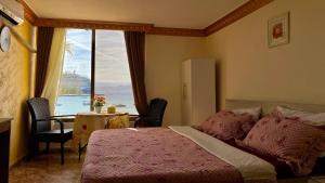 a bedroom with a bed and a table and a window at Al-Amer Aqaba Beach Hostel in Aqaba
