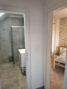 a bathroom with a shower and a glass door at Bobelino in Povlja +14 photos