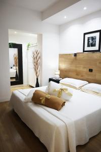 a bedroom with a large white bed with white pillows at Villa Alba Boutique Hotel in Pescara