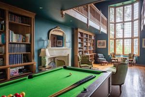 a billiard room with a pool table and a fireplace at Riverbank house - Cookham in Cookham