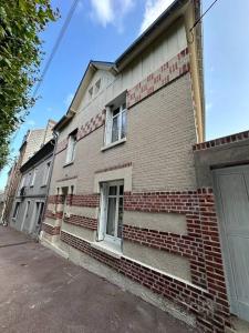 a brick building with stairs on the side of it at Luxueuse maison Hypercentre Dieppe in Dieppe