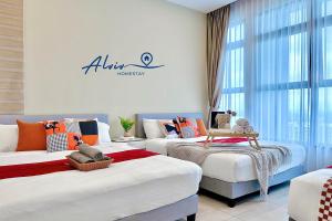a room with two beds and a sign on the wall at Atlantis Melaka I 5-11pax I 5min JonkerSt BY Alviv Management in Melaka