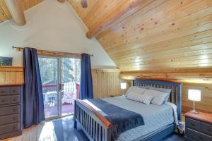 a bedroom with a bed and a wooden ceiling at The InnLet - Comfy Cabin By Conkling Marina in Worley