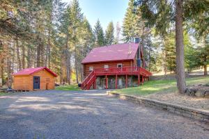 a log cabin with a red roof in a forest at The InnLet - Comfy Cabin By Conkling Marina in Worley