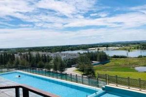 a swimming pool on top of a building with a view of a lake at Champs Elysees by Landmark @ Kampar in Kampong Malim Nawar +8 photos