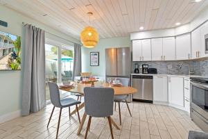 a kitchen with a table and chairs in a kitchen at Sea Foam - 173 in Siesta Key