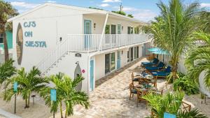 a view of the side of a building with tables and chairs at Sea Foam - 173 in Siesta Key