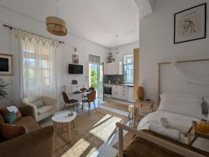 a bedroom with a bed and a living room at The Valkyries 1 in Leonidio