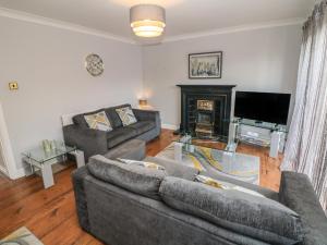 a living room with two couches and a fireplace at The Croft, North Staffordshire in Stoke on Trent