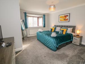 a bedroom with a large bed and a window at The Croft, North Staffordshire in Stoke on Trent