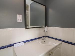 a bathroom with a sink and a mirror at The Croft, North Staffordshire in Stoke on Trent +17 photos