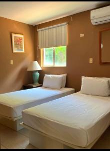 two beds sitting next to each other in a bedroom at VistaMar - La Morada del Ocaso in Playa Hermosa