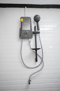 a hair dryer on a wall with a microphone at The Bright House, Koh Phi Phi in Phi Phi Don