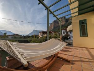 a hammock on a patio with mountains in the background at The Valkyries 1 in Leonidio