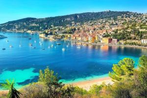a view of a beach with boats in the water at Charmante maison Climatisé avec Netflix et Disney plus in Touet-de-lʼEscarène
