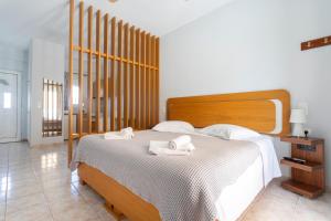 a bedroom with a bed with two towels on it at Vasilis Apartments Beachfront in Ermioni