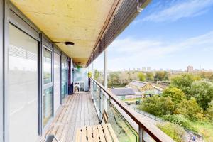 a balcony with a wooden bench on a building at Appealing 2 Bedroom apartment in Bethnal Green in London